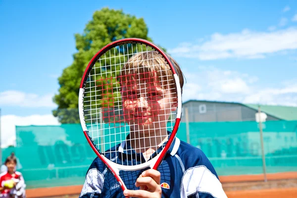 Child looks happy and satisfied after the tennis match — Stock Photo, Image