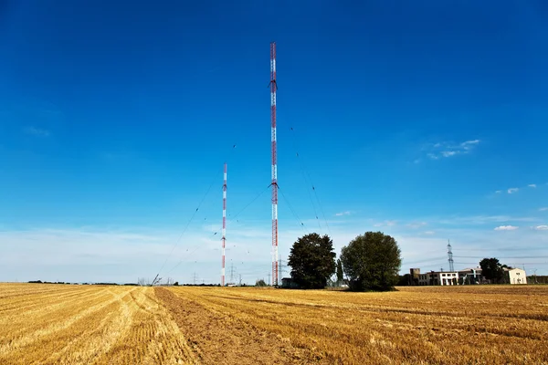 stock image Radio installation in golden acres with blue sky