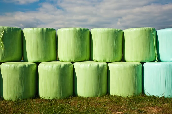 stock image Bale of straw infold in plastic film (foil) to keep dry in autom