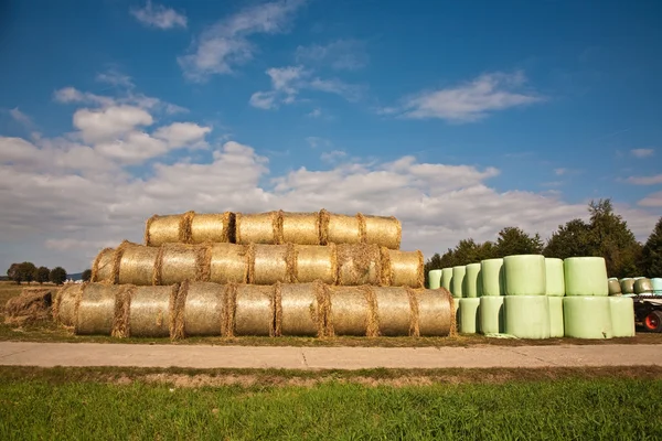 Bale of straw infold in plastic film (foil) to keep dry in autom Stock Picture