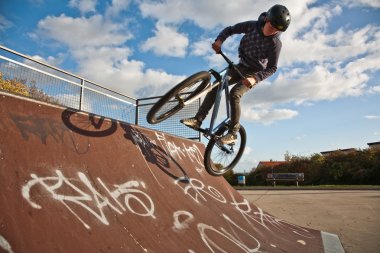 Boy with bike at the skate park clipart