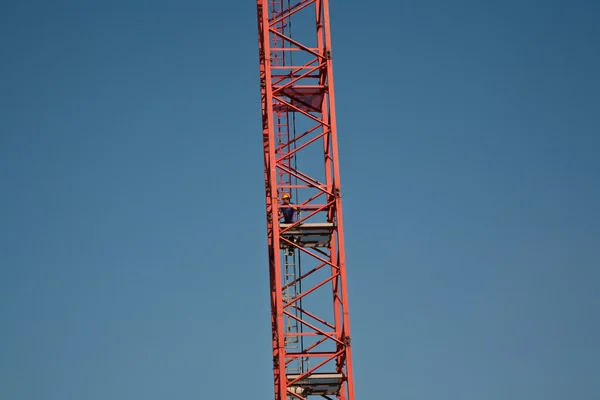 Man climbing up the tower crane — Stock Photo, Image