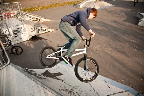 Мальчик едет на велосипеде в скейтпарк — стоковое фото