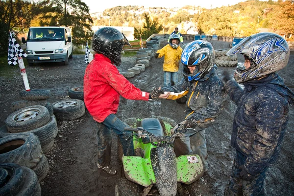Ребенок любит гонки с квадроциклом на грязной четырехколесной дорожке — стоковое фото