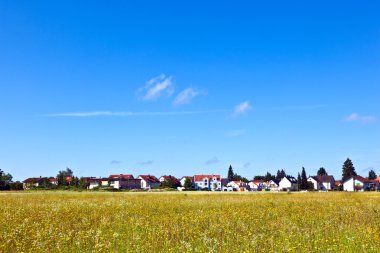 Housing area in rural landscape clipart