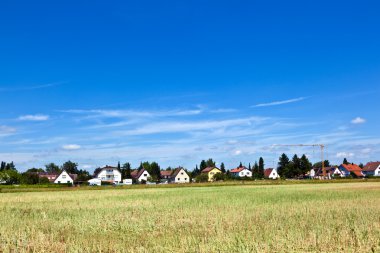 Housing area in rural landscape clipart