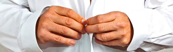 Man closing his shirt