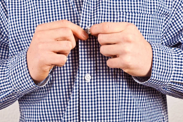 Boy closing his shirt — Stock Photo, Image