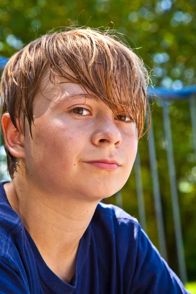 Young happy boy sweating and exhausted from sports — Stock Photo, Image