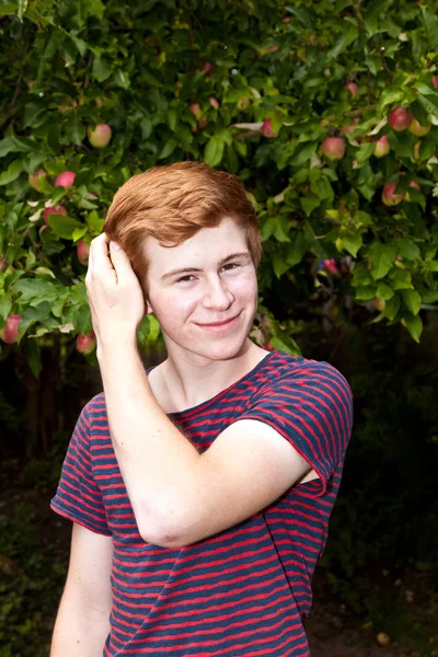Attraktiver, fröhlich lächelnder Junge im Garten — Stockfoto