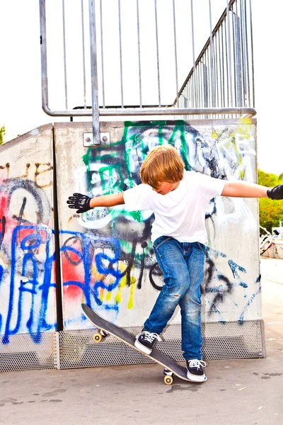Мальчик отдыхает со скейт-бордом в скейт-парке — стоковое фото