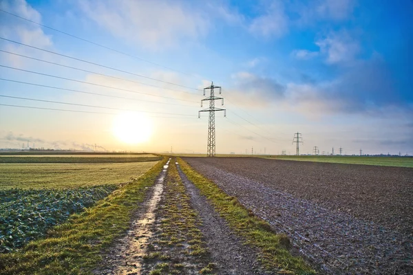 Electrical tower in landscape with dark clouds — Stock Photo, Image
