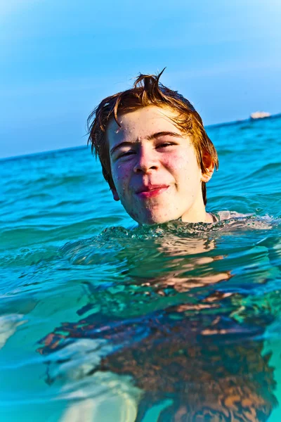 Ragazzo con i capelli rossi si sta godendo l'acqua calda e limpida alle bellezze — Foto Stock