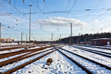 Rails in winter at the station clipart