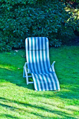 Deck chair on the grass without clipart