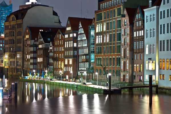 stock image Old townhouses at the canal in Hamburg by night