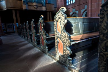 Old wooden historic benches in the cathedral of Wetzlar clipart