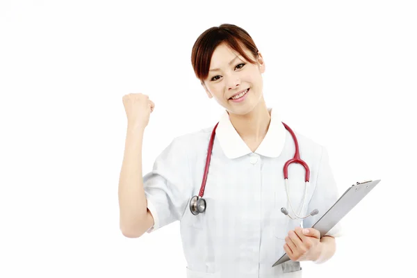 Jovem enfermeira mostrando braço — Fotografia de Stock