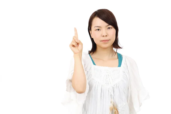 Portrait of young asian woman pointing — Stock Photo, Image