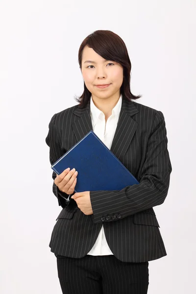 Young asian business woman holding a book — Stock Photo, Image