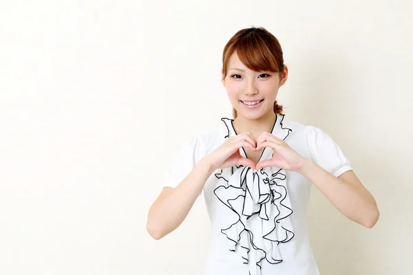 Ευτυχισμένη γυναίκα της Ασίας κάνει σχήμα καρδιάς από τα χέρια της — Φωτογραφία Αρχείου