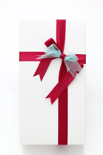 White gift box with red ribbon — Stock Photo, Image