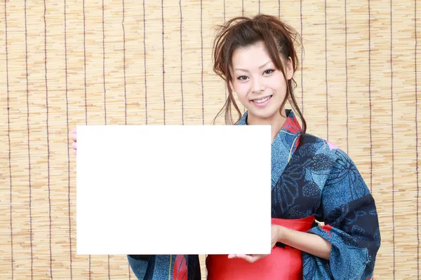 Japanese woman in traditional clothes of Kimono with billboard — Stock Photo, Image