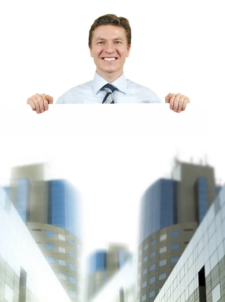 Homem de negócios segurando um quadro branco com edifícios corporativos — Fotografia de Stock