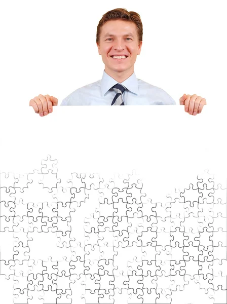 Jistý obchodní muž držící bílou puzzle board pro kopírování lázně — Stock fotografie