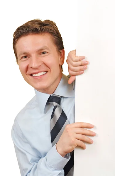 Smiling business man holding a white board — Stock Photo, Image