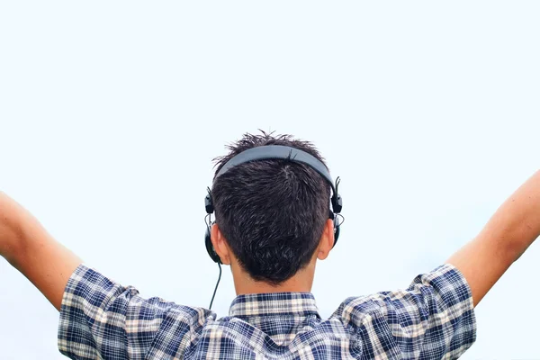 小男孩在他头上的耳机欣赏音乐， 免版税图库图片