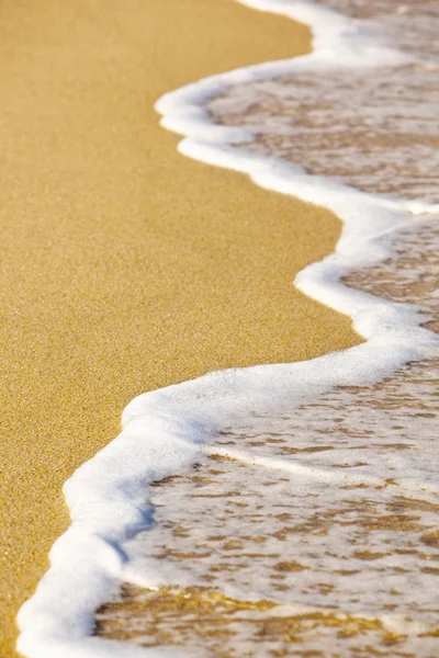 Mořská pěna na písku — Stock fotografie