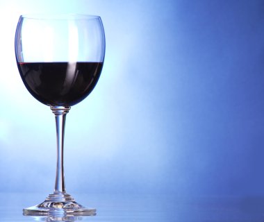 Glass of red wine over blue clipart