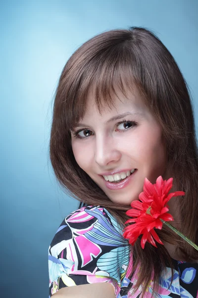 Young woman with artificial flower — Stock Photo, Image