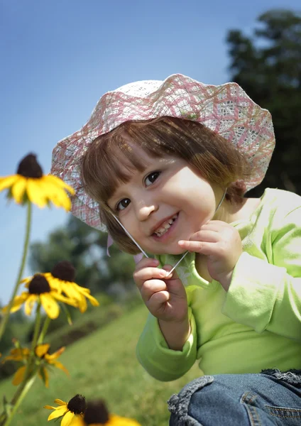 Baby on flower lawn — Stock Photo, Image