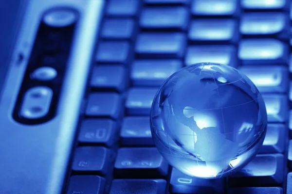 stock image Glass globe on keyboard