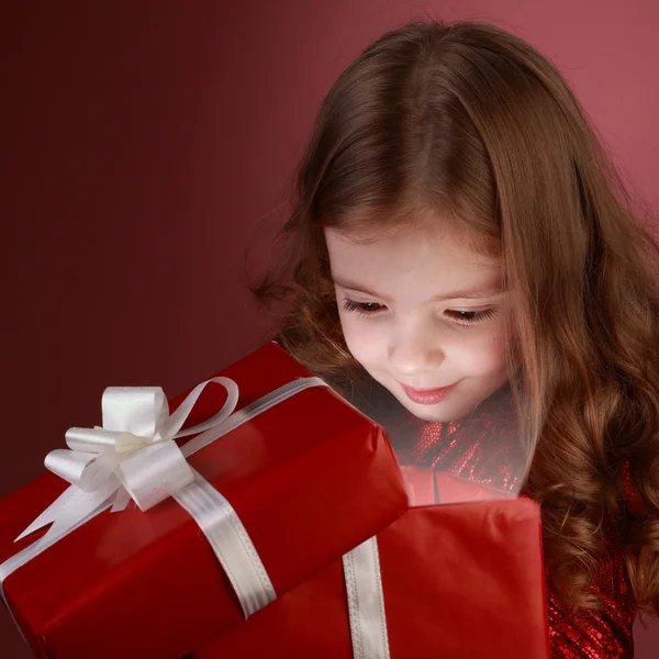 Litle girl open red gift box — Stock Photo, Image