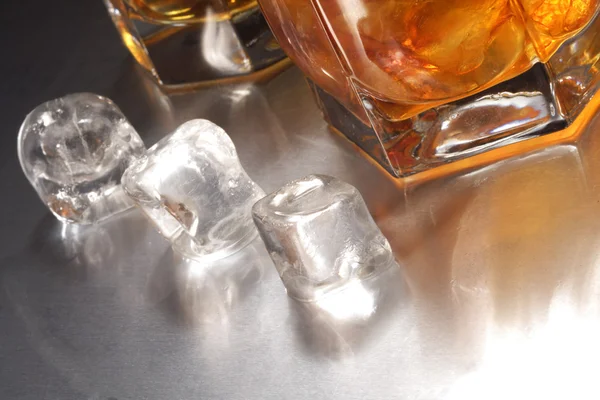 Ice cube and glasses — Stock Photo, Image