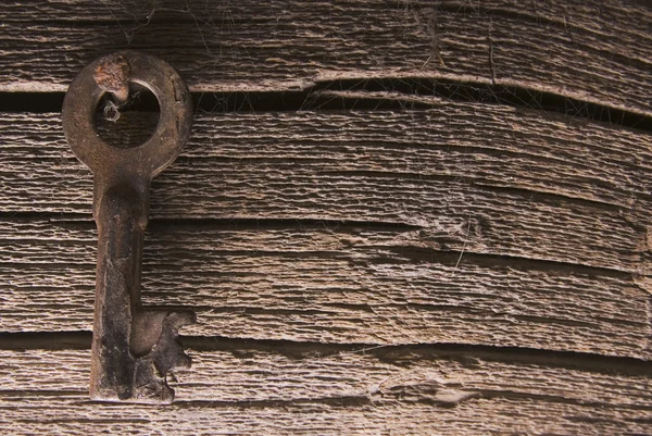 Old key on wood deck — Stock Photo, Image