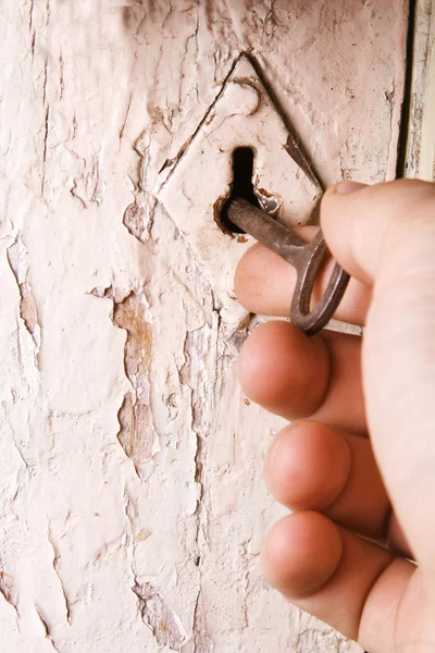 Old key opening the door — Stock Photo, Image