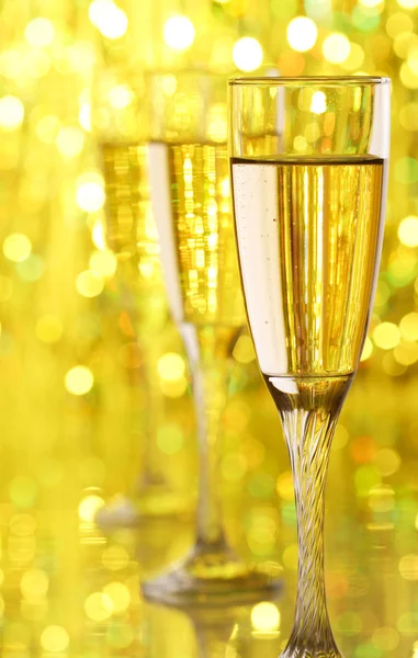 Glasses with champagne on abstract color background — Stock Photo, Image