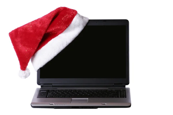 stock image Laptop with a Santa hat on the corner