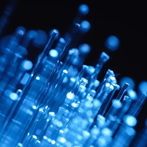Optics fibers on blue background — Stock Photo, Image