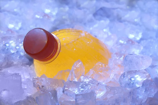 Помаранчева пляшка в льоду — стокове фото