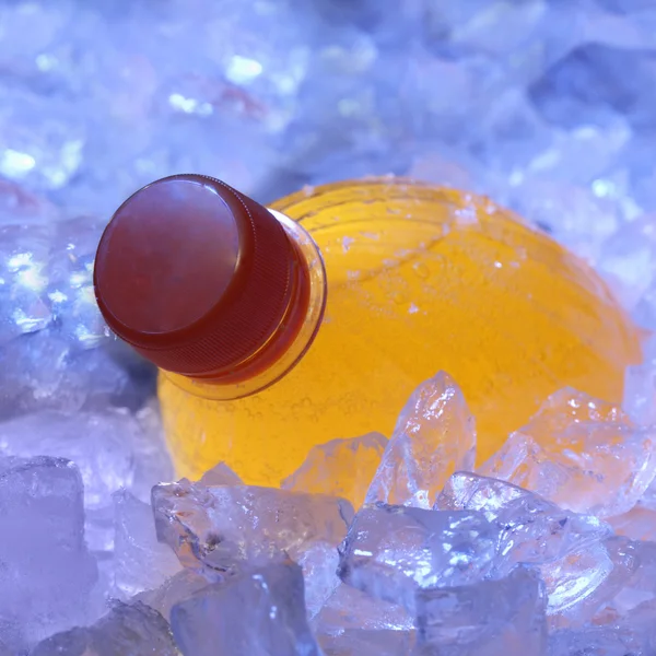 Orange bottle in ice — Stock Photo, Image