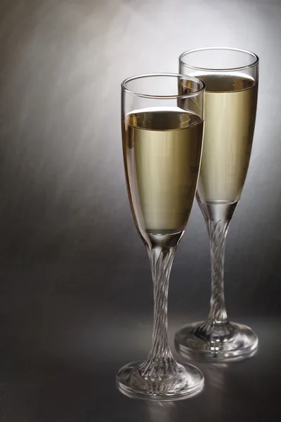 Glasses with champagne on abstract color background — Stock Photo, Image