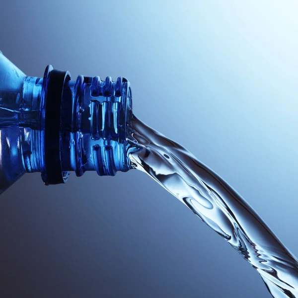 Water flows from bottle — Stock Photo, Image