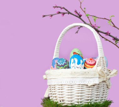 Basketful of colorful hand painted Easter eggs clipart