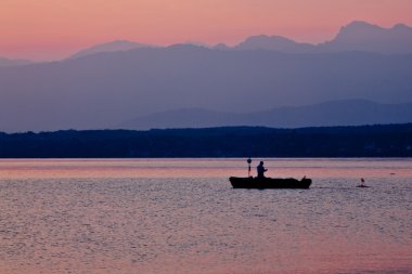 Fisherman in the early morning light clipart