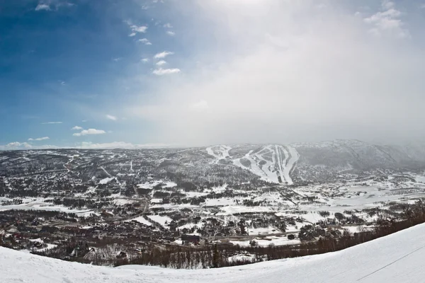 Panorama of winter mountain slopes with ski routes and snowstorm — Stock Photo, Image
